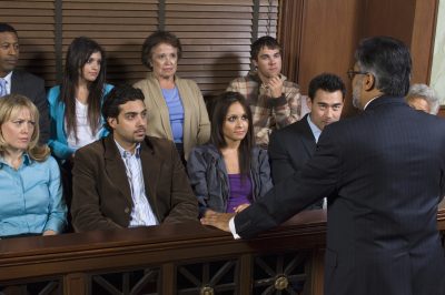 An advocate communicating with the jurors in a court house.