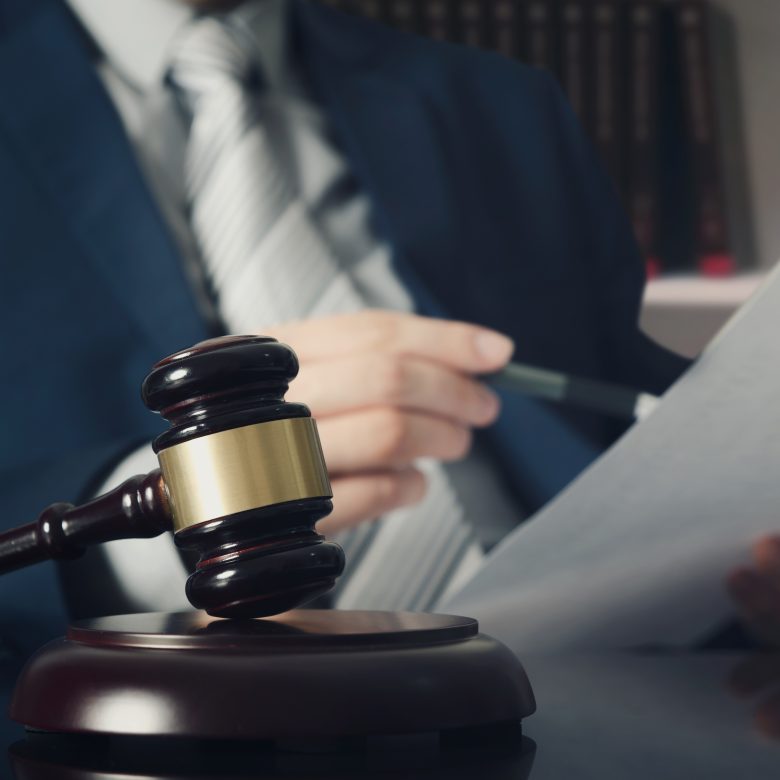 Wooden gavel on lawyer's desk.